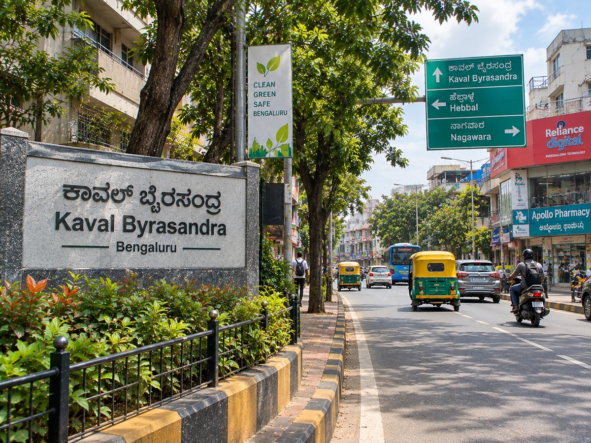 Kaval Byrasandra Bangalore road with shops, vehicles and tree-lined streets