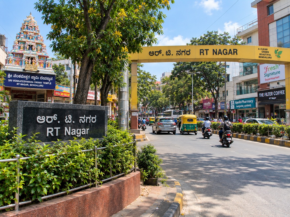 RT Nagar Bangalore busy commercial road with shops, traffic and greenery
